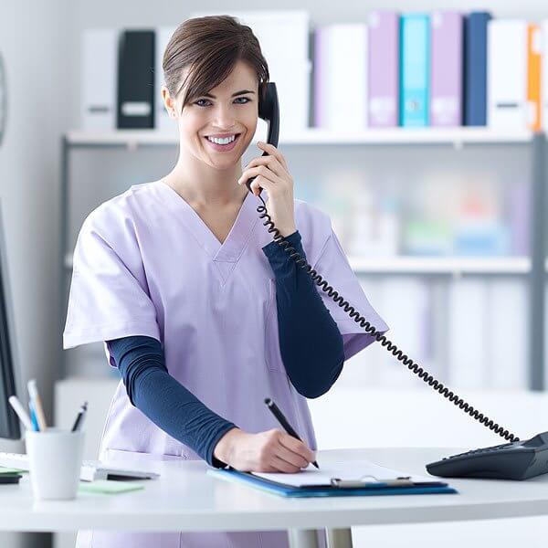 Woman Nurse Answering the Phone in the Office