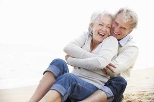 Smiling senior couple on a beach