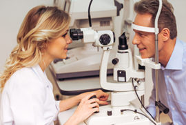 Female Doctor Looking at Male Patients Eyes