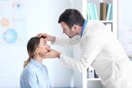 Male Doctor Looking at a Female Patients Eyes