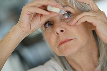 Older Woman Putting Eye Drops In