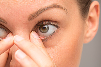 Closeup of Woman Rubbing Her Eyes