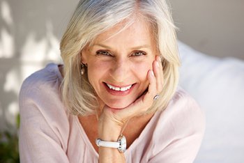 Woman Smiling With Hand on Her Chin